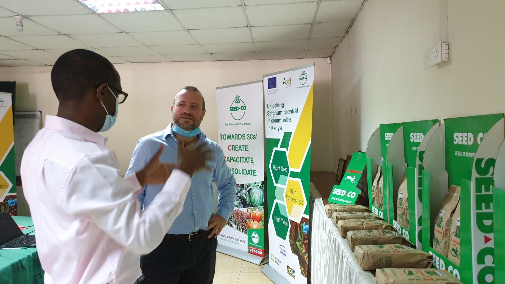 Two men talking and seed Co Products